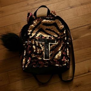 Justice, sparkly color flip mini backpack.